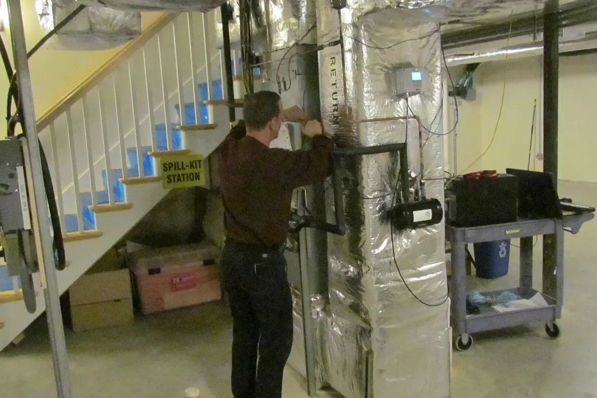 Building equipment monitored by a NIST technician; energy work requires a whole-house view